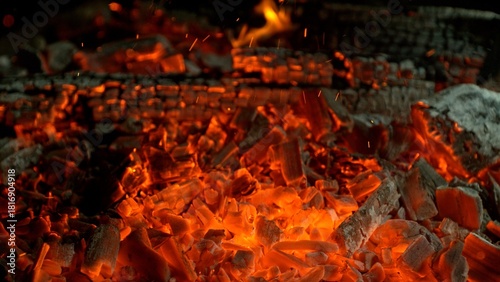 Close-up of Hot Embers with Flying Sparks . Concept of heating grills or ovens