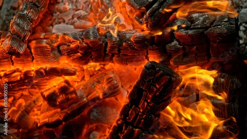 Close-up of Hot Embers with Flying Sparks . Concept of heating grills or ovens