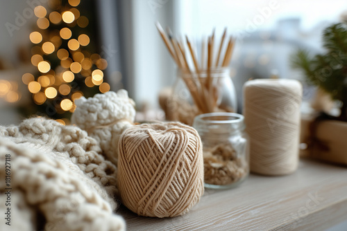 Partial silhouette near crystal clear Christmas decor and yarn craft materials in warm inviting room, with copy space