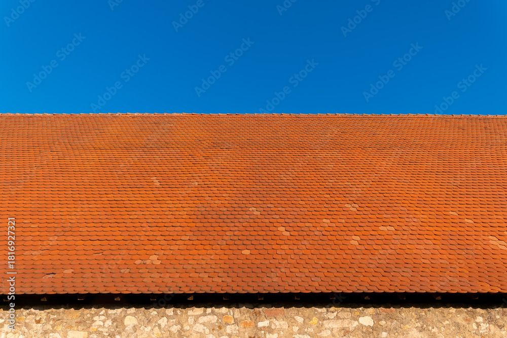 Fototapeta premium Beautiful terracotta roof under a bright blue sky on a sunny day in the countryside