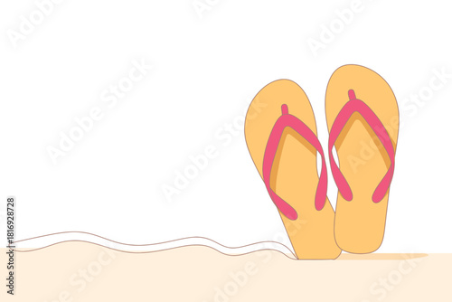 Pair of yellow flip flops with pink straps on a sandy beach