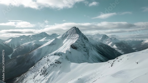 Stunning snow covered mountain peaks against blue sky beckon adventure seekers