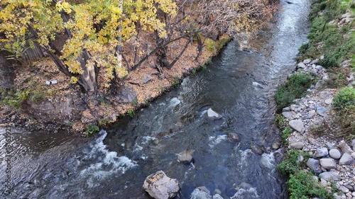 the flowing river and the stone shore, view from above
