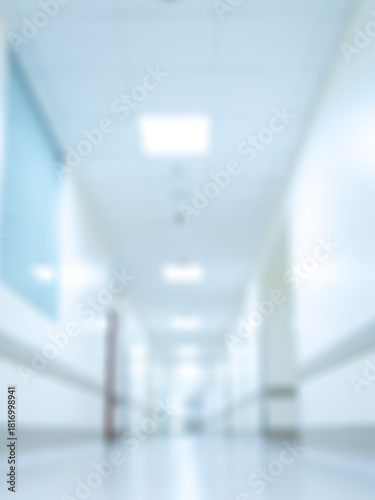 Blurred view of an empty hospital hallway with lights shining down