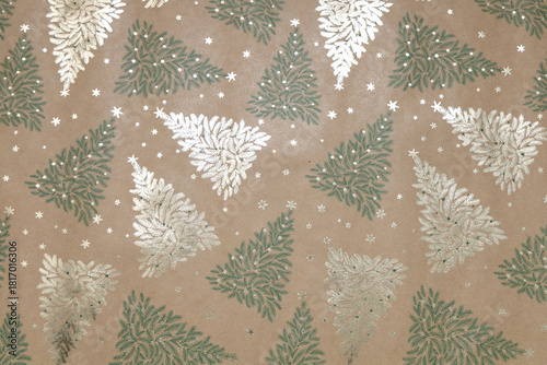 Kraft background with green and gold Christmas trees and snowflakes
