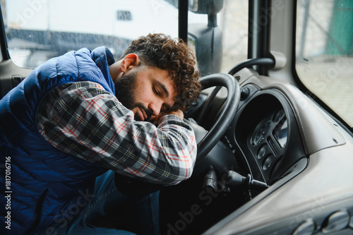 Tired truck driver sleeping on steering wheel