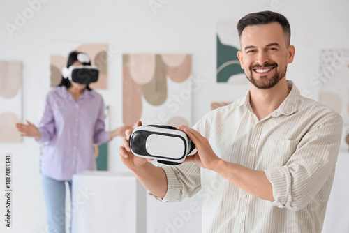 Young man with VR glasses i...