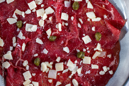 Beef Carpaccio cold appetizer with parmesan