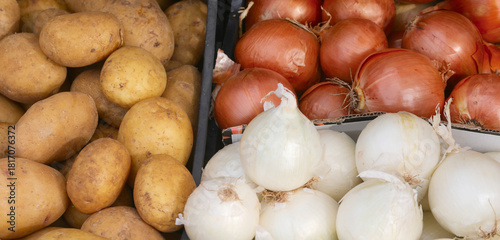 Crates at the fruit and vegetable stall featuring potatoes and onions
