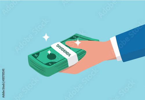 Dividends stock payment, passive income from dividend yield concept, rich and wealthy businessman hand holding pile of dollar money banknotes with the word Dividends.