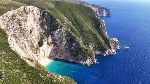 Aerial drone video of not so famous paradise bay and caves of Saint Andrews islet creating a blue lagoon visited by yachts and small boats in the Northern part of Zakinthos island, Ionian Sea, Greece