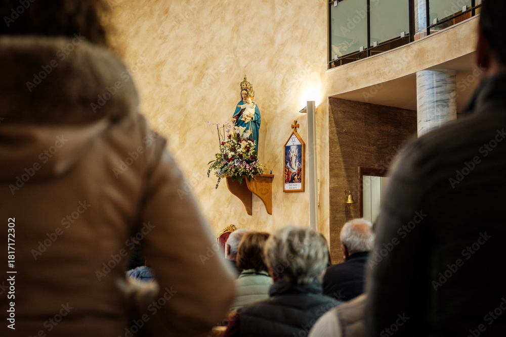 Obraz premium Statue of the Virgin Mary Adorned with Flowers in a Church