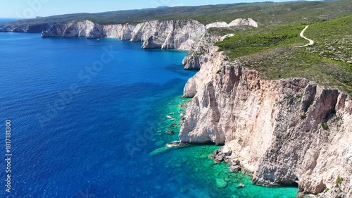 Aerial drone cinematic video of paradise bay with scenic white cliffs covered with limestone and sea caves creating a blue lagoon in tropical exotic destination island