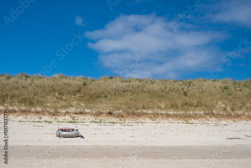 beach on tresco with boat Isles of Scilly 