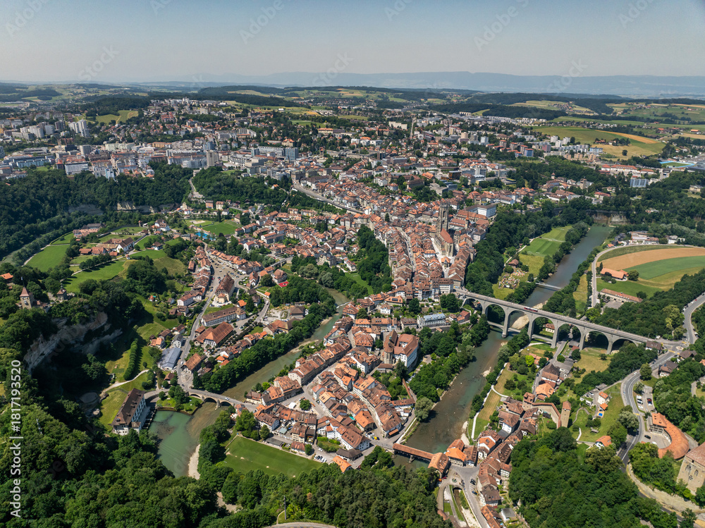 Obraz premium Panoramic aerial view of old medieval town of Fribourg, Switzerland in Europe. Bridges crossing the river, Swiss city on a summer day.
