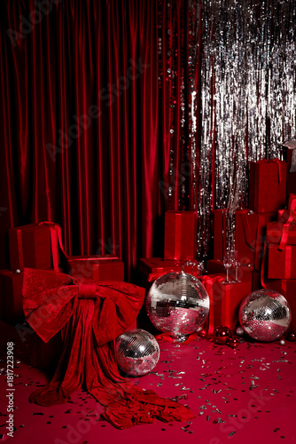 Red glamorous Christmas party scene with gifts, disco balls and silver tinsel