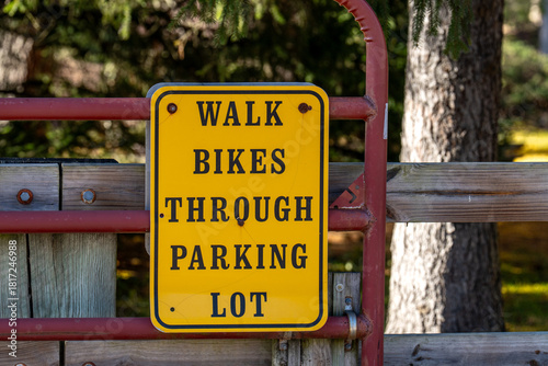 Walk bikes through parking lot sign
