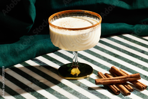 Eggnog cocktail with cinnamon sticks