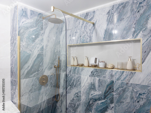 Luxurious marble shower with elegant gold fixtures inviting relaxation