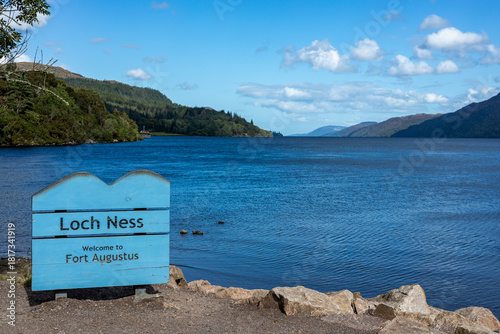Loch Ness lake with the famous blue sign on a sunny summer afternoon.