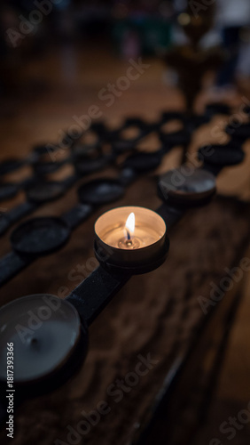 Lit Tealight Candle in Church Votive Holder