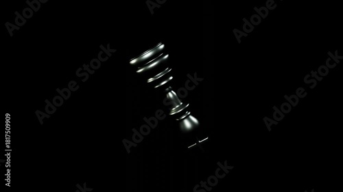 Silver chess king piece spinning continuously on black background with smooth motion