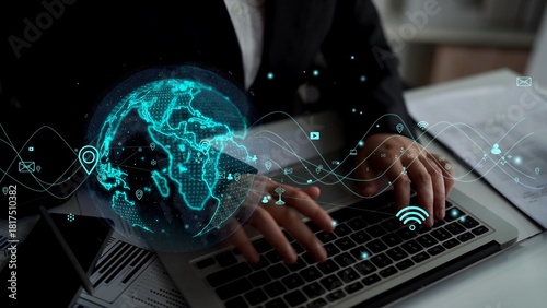 Billede på lærred A businessman engages with a laptop, surrounded by a vivid globe and digital icons, symbolizing advanced technology and global connectivity in a modern workspace