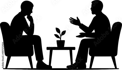 Two people in silhouette having a discussion sitting across from each other in a counseling session