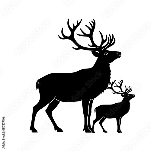 A black silhouette of a majestic adult stag with large antlers standing with a young fawn.