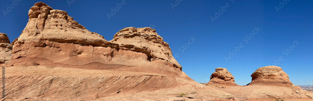 Fototapeta premium Beehive and New Wave trails in Glen Canyon National Recreation Area near Page, Arizona. Sandstone outcroppings, windswept rock formations, breathtaking views of desert landscape and distant mountains.