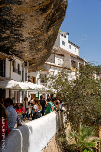 Wallpaper Mural Setenil de las Bodegas village built into rock with people enjoying a sunny day at a restaurant in Andalusia, Spain Torontodigital.ca