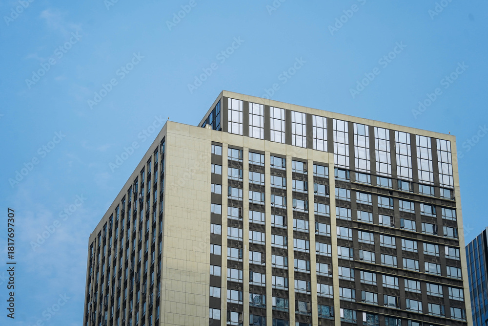 Fototapeta premium Low angle view of skyscraper with glass window and clear blue sky background for business and finance concept