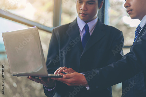 New employee working with laptop, training has been guided and consulting by colleagues. Selected focus