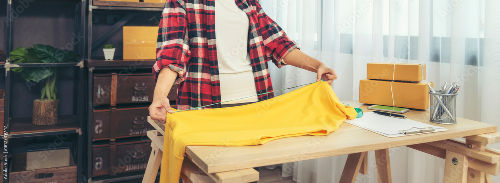 Obraz premium Banner Asian woman startup small business home office. Banner Online seller young asian woman use digital tablet checking online order stock. Woman using tablet check stock shipping with copy space