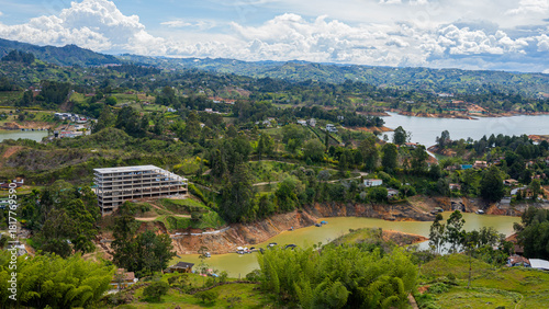 View of La Piedra del Peñol in Guatapé, Colombia, surrounded by the reservoir and colorful landscape, iconic tourist destination near Medellín