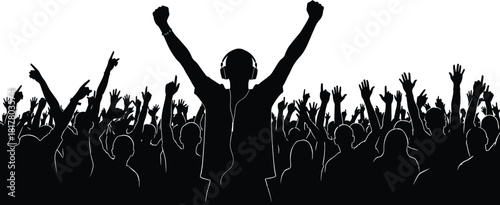 Silhouette of ecstatic person wearing headphones with fists raised over cheering crowd, symbolizing music lover, fan, festival, freedom, and enjoyment.