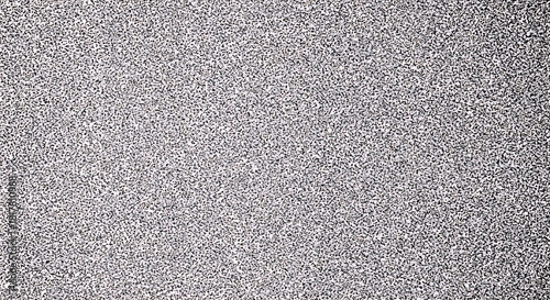 Black and white speckled texture with random small dark spots on light background pattern abstract