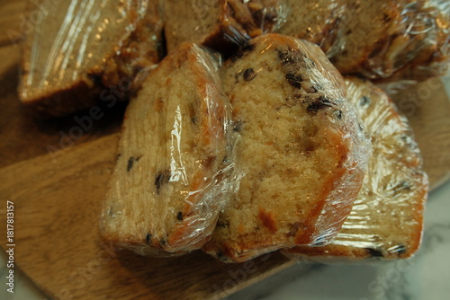 Saran plastic wrapped sliced blueberry muffin slices, bake sale pastry