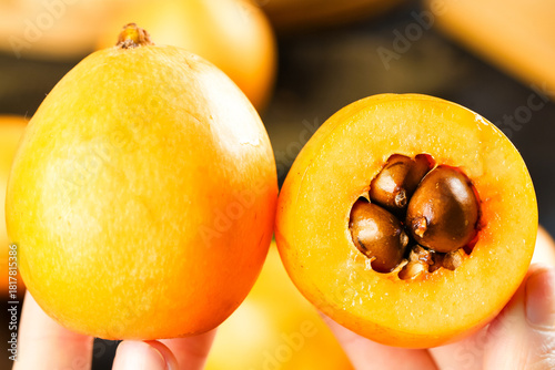 Canvas Print Fresh Loquat Fruit from Yunnan Mountains - Golden Asian Fruit with Seeds Exposed