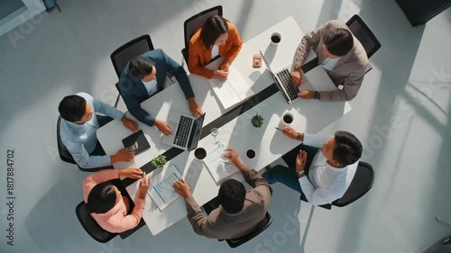 Cinematic 4K top-view of six colleagues brainstorming with documents and laptops, ultra-clean white workspace, shadowless lighting, calm corporate atmosphere