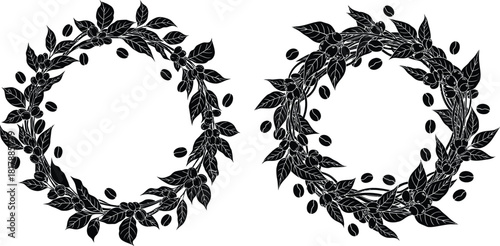 Two circular wreaths composed of coffee plant branches with leaves, ripe berries, and scattered roasted beans