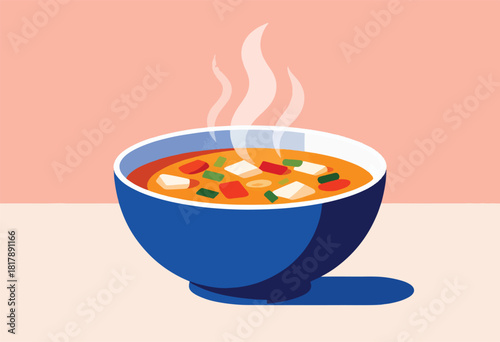 A blue bowl of vibrant soup with tofu, veggies, and steam rising against a pastel peach backdrop