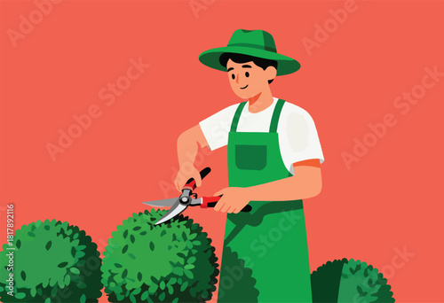 A person in a green hat and apron trims a bush with large shears. The background is a salmon color