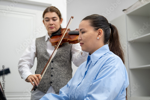 Playing music in the school, rehearsal with violin and piano.