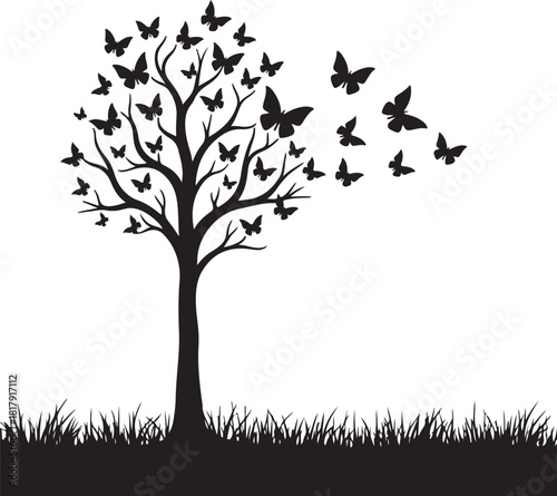 Black tree with butterflies flying away over grass
