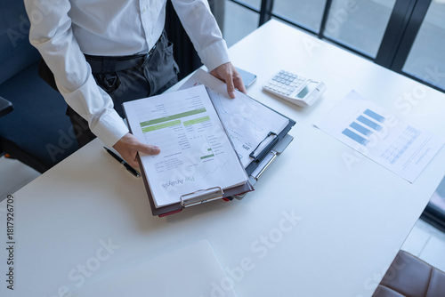 Businessman holding a lot of documents paper work concept