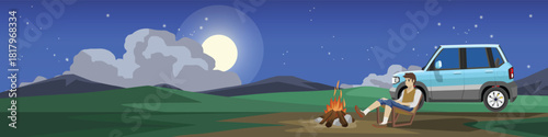Horizontal or landscape view of camping on hills. Male tourist sits on picnic chair next campfire. Off road vehicle is parked behind on a wide open area. Background of mountain night scene with moon.
