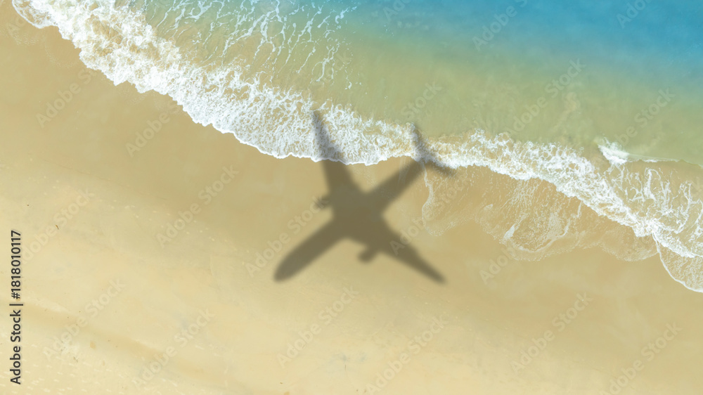 Naklejka premium Aerial view of shadow passenger plane silhouette and sandy beach blue sea with waves at sea beach summer vacation sea travel concept 