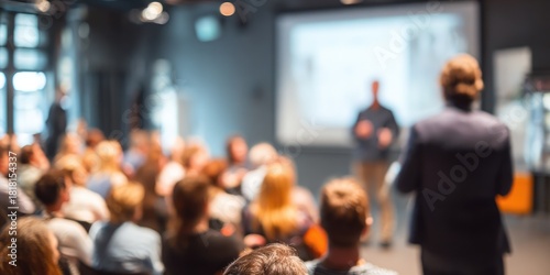 Blurred audience at university conference speaker giving presentation in bright hall scientific workshop high-quality training event with engaging background