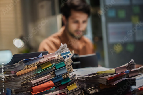 Overworked Exhausted Office latin Man Working Late at Night with Stressful Paperwork and Deadline Pressure